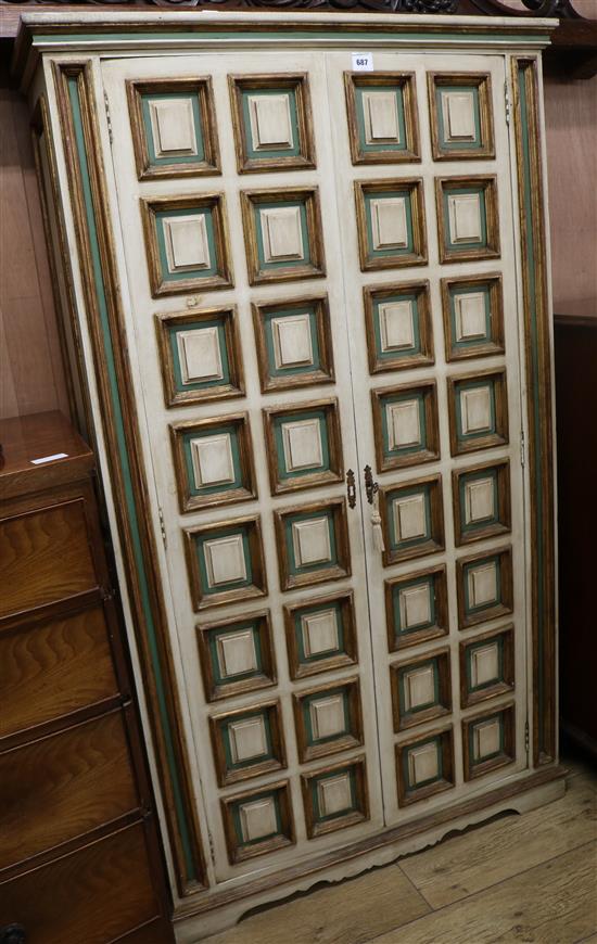 An Italian late 17th century style painted and parcel gilt panelled two door cupboard, H.171cm